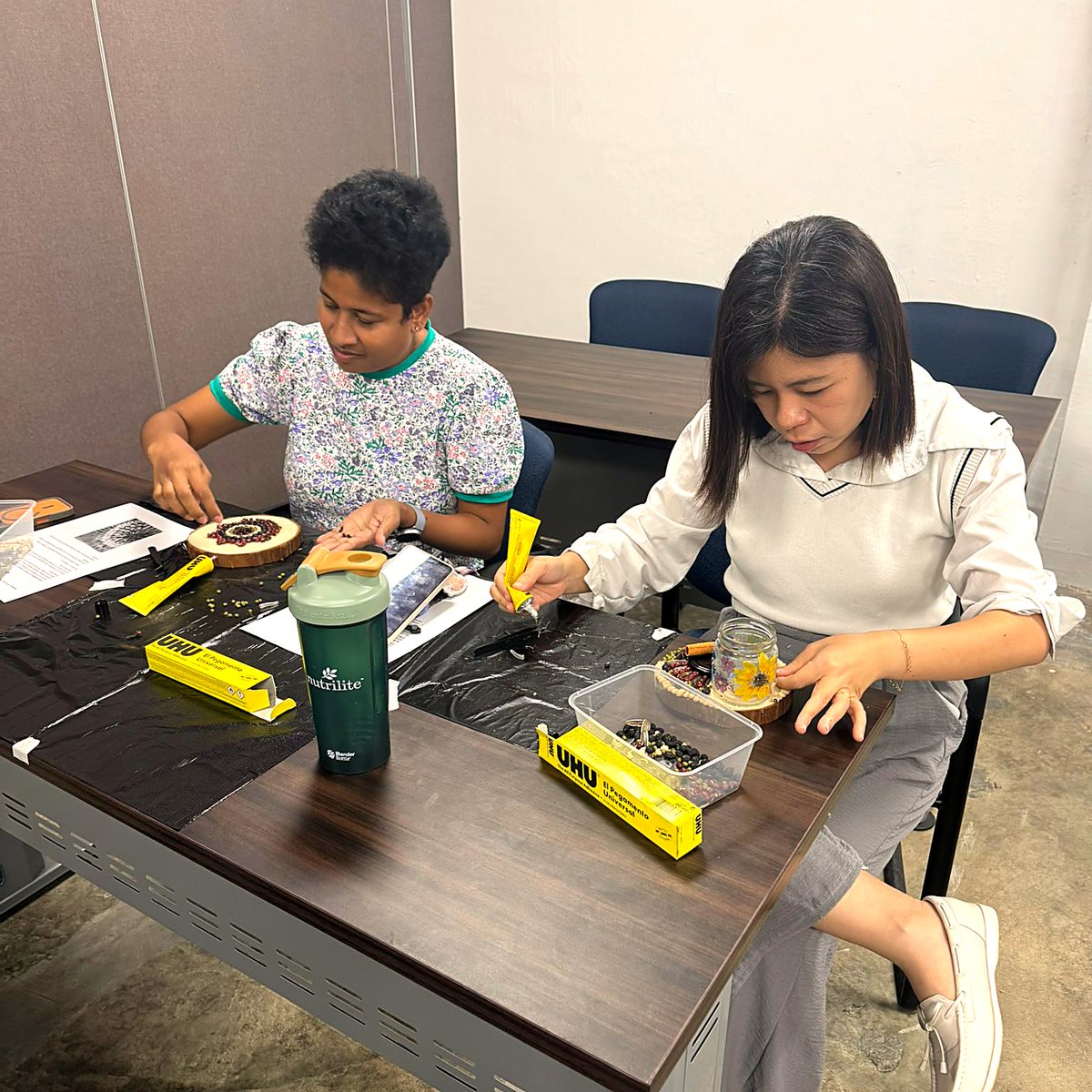 Two participants working on their seed mandalas
